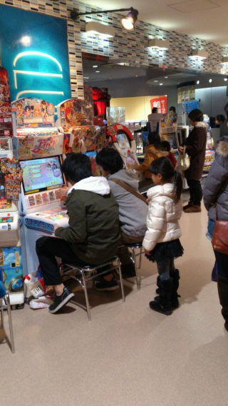 Illustration for article titled Two Dudes Making a Little Girl Wait To Play an Arcade Game That's... for Little Girls